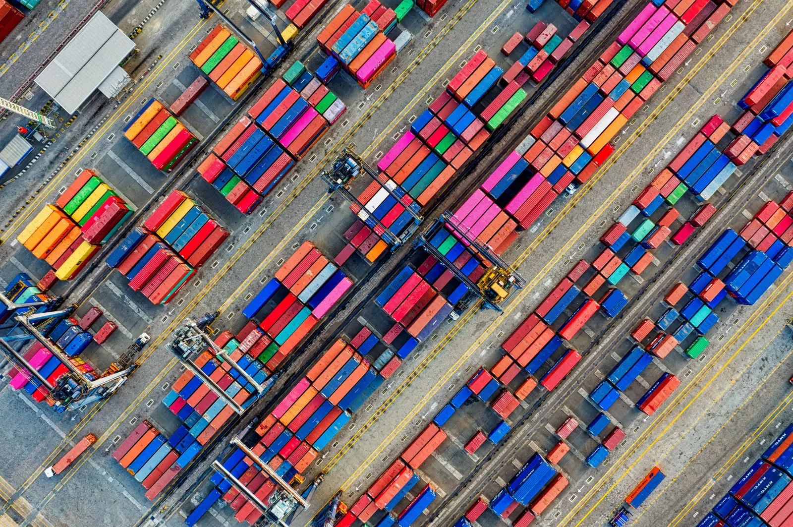 Aerial view of rows of colourful 20FT and 40FT shipping containers in a storage yard