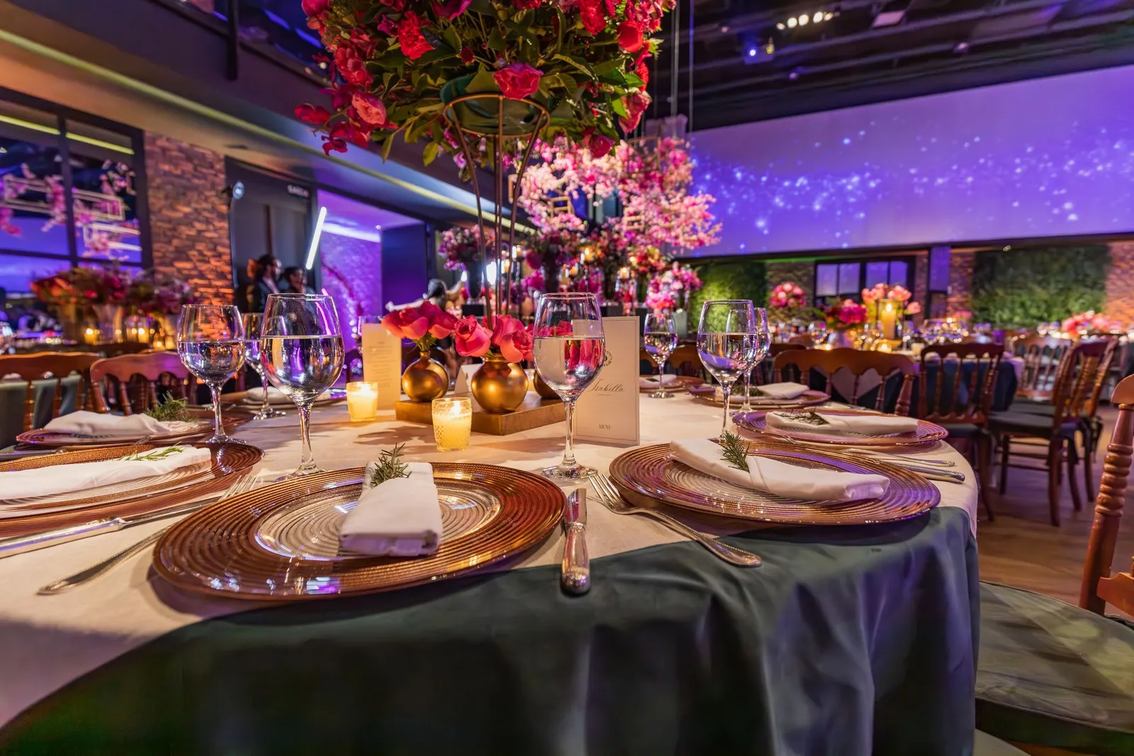 Elegant gala dinner table setting with floral centrepiece